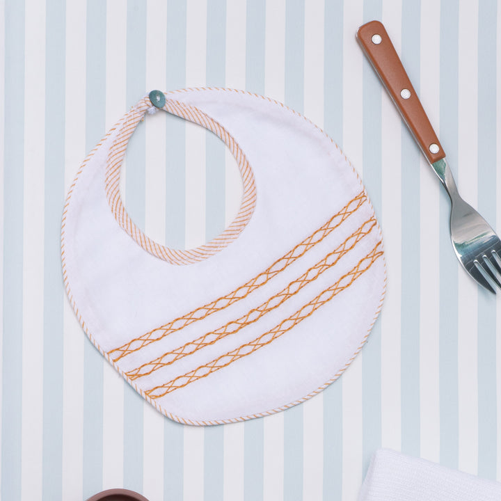 Bavetta in mussola di cotone bianco con ricamo arancio